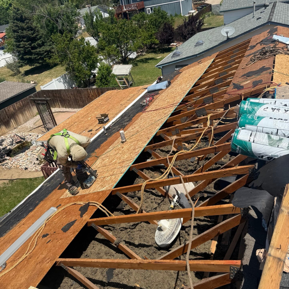 roof tear-off exposing rafters and framing during full roof replacement project