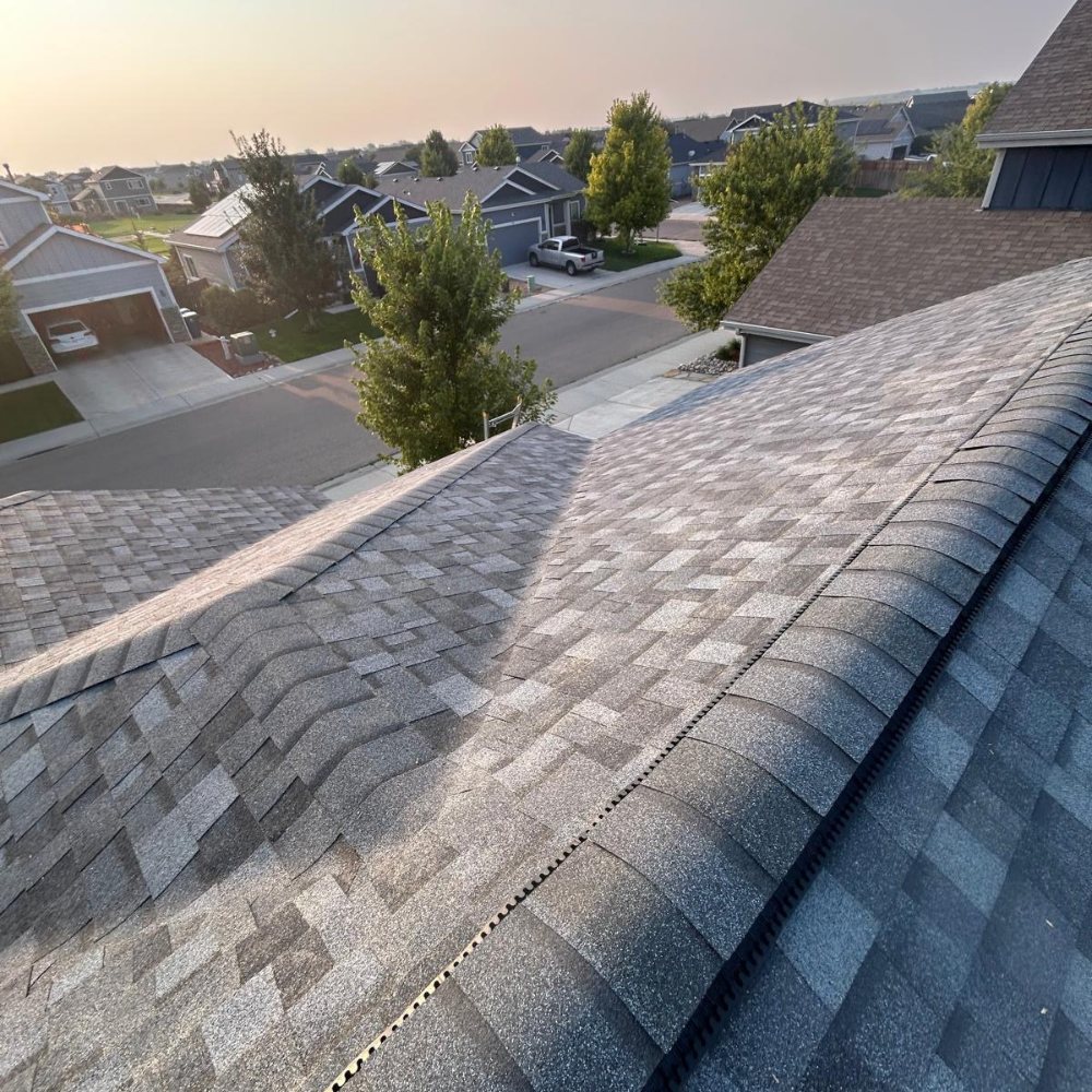completed residential roof with ridge vent and new architectural shingles installed