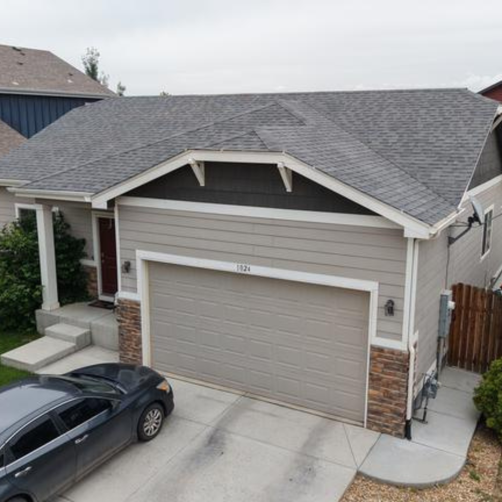 residential home with newly installed asphalt shingle roof after storm restoration